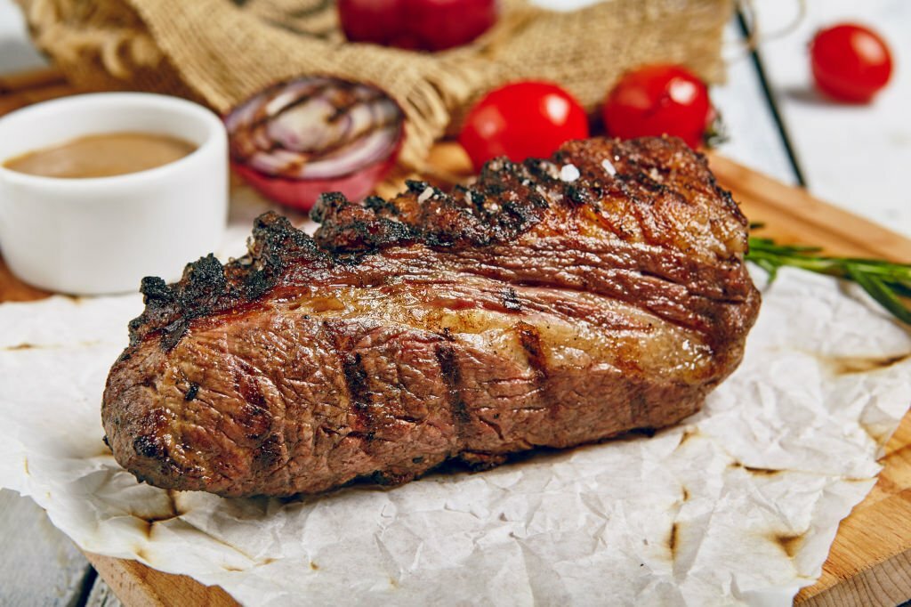 Tri-Tip Beef Steak on Wooden Background